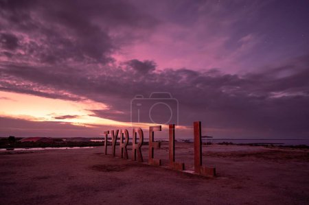 Photo for A ' Tyrrell' word on sandy beach during sunset - Royalty Free Image