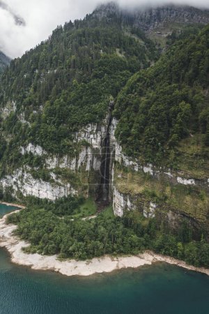 Photo for A drone vertical shot of a river and mountain with waterfall and greenery - Royalty Free Image