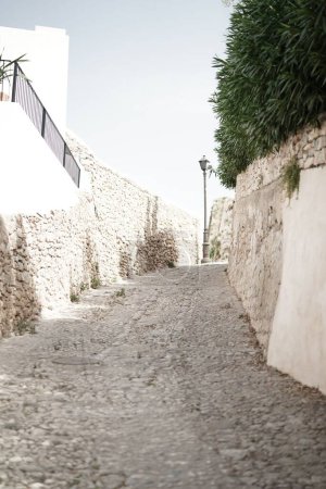 Photo for An alley in a city with stone walls around - Royalty Free Image