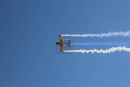 Photo for A low angle shot of a RC airplane flying in a cloudless blue sky - Royalty Free Image
