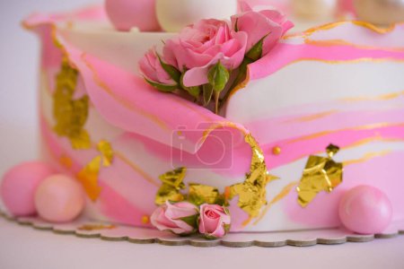 Photo for A closeup of a cake decorated with pink roses and balls - Royalty Free Image