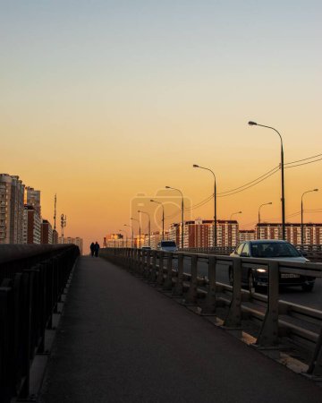 Téléchargez les photos : Un plan vertical des voitures conduisant au-dessus du pont au coucher du soleil. Moscou, Russie - en image libre de droit