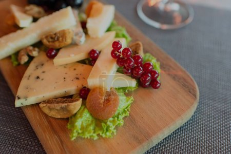 Photo for A closeup shot of a cheese plate prepared in the ambient of a high-class elite steak house restaurant - Royalty Free Image