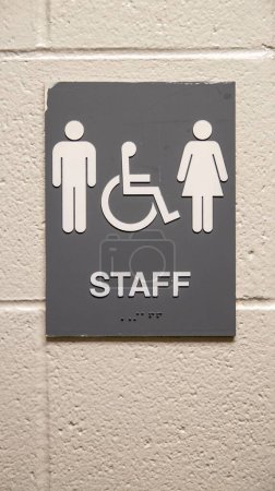 Photo for A closeup of staff restroom sign hanging on a white wall - Royalty Free Image