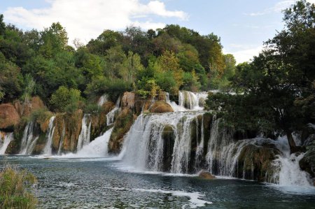 Photo for A landscape view of beautiful waterfall surrounded by trees in Krka National Park in Croatia - Royalty Free Image