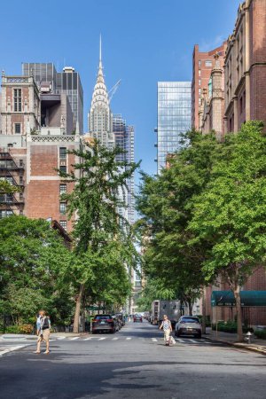 Photo for The Chrysler building is seen over the apartment buildings lining East 43rd Street in New York City. - Royalty Free Image