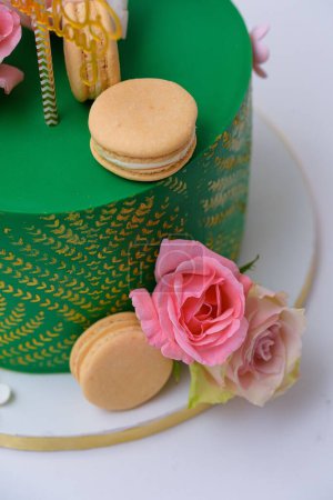 Photo for A vertical shot of a green cake decorated with macaroons and flowers - Royalty Free Image