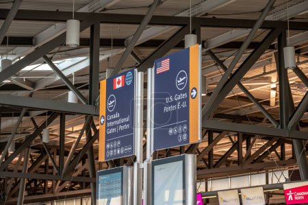 Photo for Ottawa, Ontario - October 21, 2022:  Canada and US Gates signs on departures level at the Ottawa International Airport. - Royalty Free Image