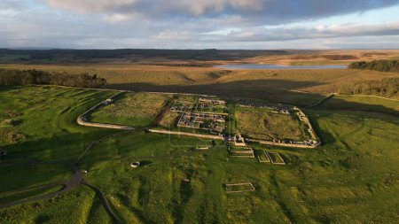 Photo for An aerial view of the remains of an auxiliary fort on Hadrian's Wall,  Housesteads Roman Fort, in Northumberland, England,in a middle of a green field - Royalty Free Image