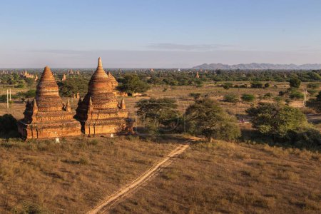Photo for Two small temples stand amongst many others on the Bagan Plains of Myanmar, a popular tourist destination. - Royalty Free Image