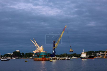 Photo for Industrial inland shipping colourful cranes in port at sunset blue hour. Engineering heavy machinery architecture and logistics concept - Royalty Free Image