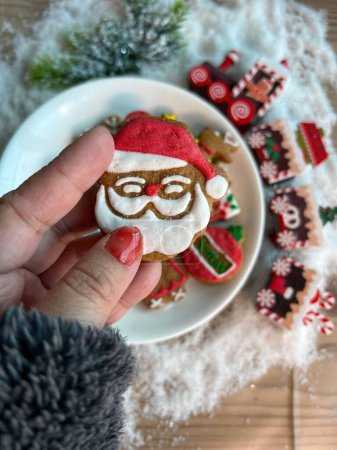 Photo for A top view of sweet Christmas cookies with Santa and a train with artificial snow on the table - Royalty Free Image