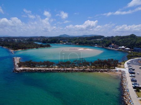 Photo for A drone view of the sandy beach of the azure sea against the trees - Royalty Free Image