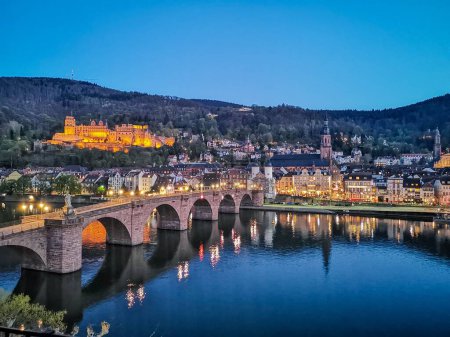 Photo for The Karl Theodor Bridge against the scenic Heidelberg cityscape in the evening - Royalty Free Image