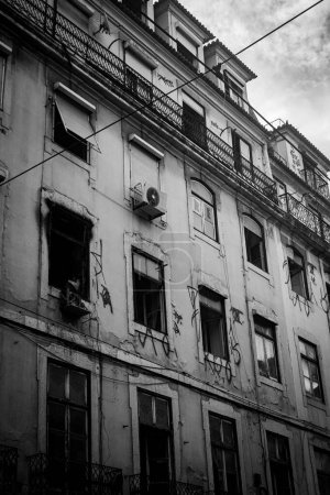 Photo for A vertical grayscale shot of an old abandoned building's facade in Rua Augusta, Lisbon, Portugal - Royalty Free Image