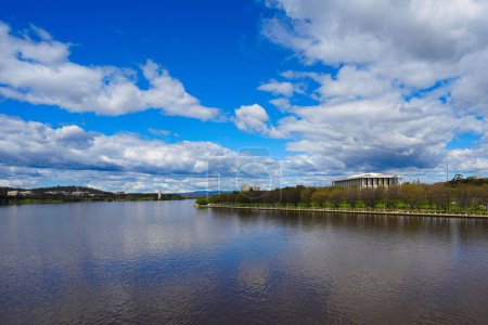 Photo for A scenic view of Lake Burley Griffin with row of trees on the shore under blue cloudy sky in Canberra - Royalty Free Image