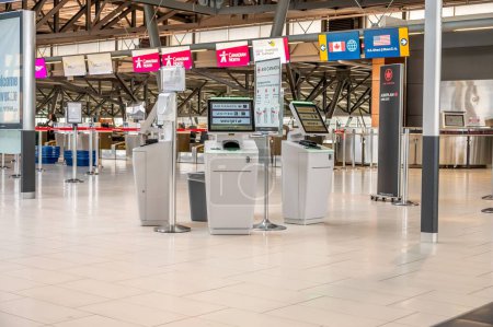 Photo for Ottawa, Ontario - October 21, 2022:  Empty self check-in kiosks  and departures facilities in the Ottawa International Airport. - Royalty Free Image