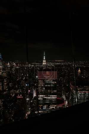 Photo for A vertical shot of the illuminated buildings of New York city at night - Royalty Free Image