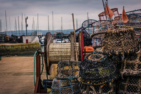 Photo for A heap of lobster trap and pots equipments and tools on the beach in Torquay, Torbay, UK - Royalty Free Image