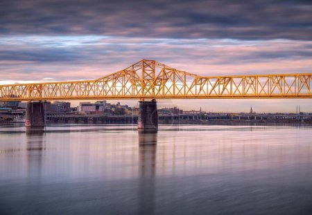 Photo for A long exposure shot of the yellow Second street bridge at sunset in Louisville, Kentucky. - Royalty Free Image