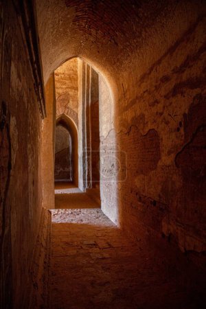 Photo for Sunlight shines into an arched brick corridor, in one of the many temples of Bagan, Myanmar. - Royalty Free Image