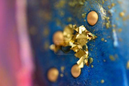 Photo for A closeup of a galaxy cake decorated with golden sprinkles - Royalty Free Image