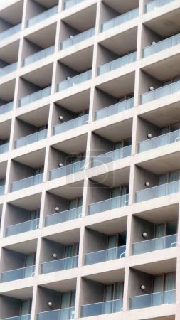 Photo for A vertical shot of the facade of a tall building with many balconies - Royalty Free Image