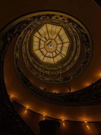 Photo for A vertical shot of a dome ceiling seen through a mysterious spiral stairway - Royalty Free Image