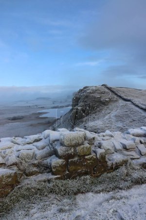 Photo for A closeup shot of the remains of the Hadrian's Wall in Northumberland National Park on a frosty winter day - Royalty Free Image