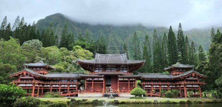 Photo for A panoramic landscape of the historic Byodo-In Temple on the background of a foggy forested hill - Royalty Free Image