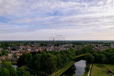 Photo for Aerial view showing historic Dutch city Groenlo with church Saint Calixtusbasiliek rising above the authentic medieval rooftops - Royalty Free Image