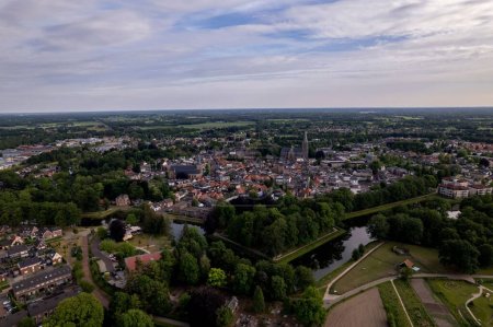 Aerial view showing historic Dutch city Groenlo with church Saint Calixtusbasiliek rising above the authentic medieval rooftops