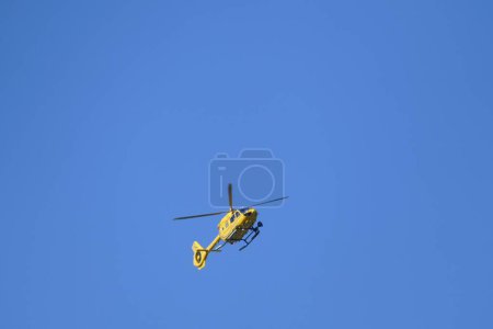 Photo for A helicopter flying in blue sky - Royalty Free Image