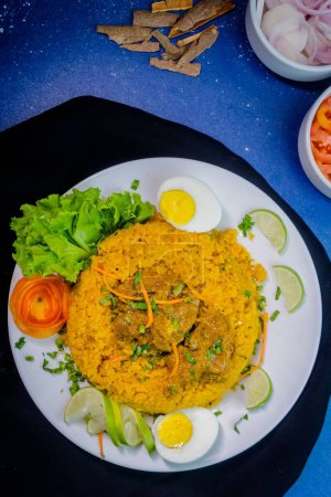 Téléchargez les photos : Une vue de dessus d'une assiette pleine du plat Biryani avec différents ingrédients en arrière-plan - en image libre de droit