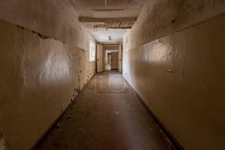 Photo for A shot of a long narrow corridor in an old prison - Royalty Free Image