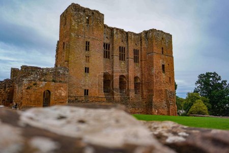 Photo for The ancient Kenilworth Castle in England surrounded by the green trees against the blue sky - Royalty Free Image