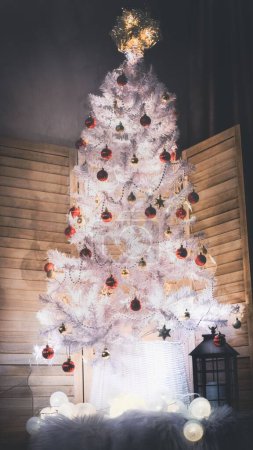 Photo for A vertical shot of a white decorated Christmas tree in a room - Royalty Free Image