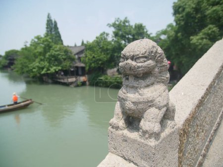 Téléchargez les photos : Une statue de lion de pierre sur le pont à Wuzhen, Chine. - en image libre de droit