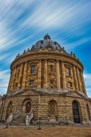 Photo for A vertical shot of Radcliffe Camera library on blue cloudy sky background in Oxford, England - Royalty Free Image
