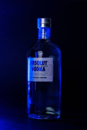 Photo for A vertical shot of a Limited edition Absolut Vodka bottle with blue lights shining on it - Royalty Free Image