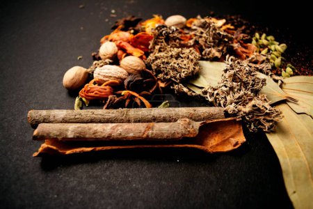 Photo for A closeup shot of indian garam masala and spices on the black background - Royalty Free Image
