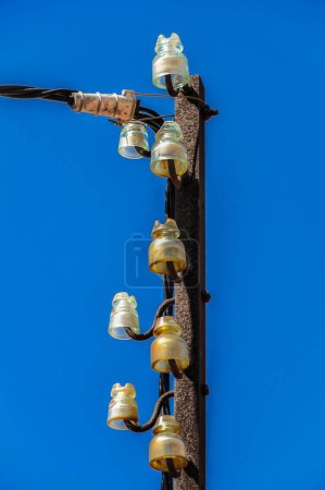 Foto de Un disparo vertical de un viejo poste de energía eléctrica contra un cielo azul - Imagen libre de derechos