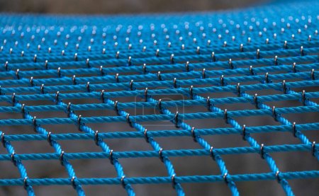 A closeup of a blue safety net, mesh