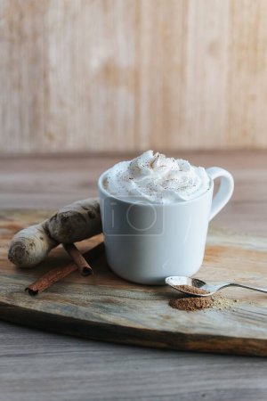 Photo for A vertical shot of a cup of hot chocolate on the wooden background - Royalty Free Image