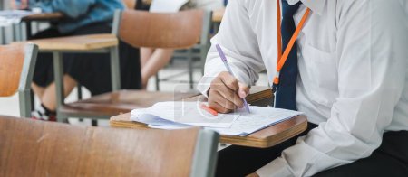 Photo for The college students writing on final examination papers in the classroom - Royalty Free Image