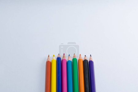 Photo for A top view of colorful wooden pencils isolated on white background with copyspace - Royalty Free Image
