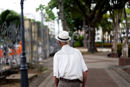 Photo for Salvador, Bahia, Brazil - October 29, 2022: Old man is walking along the streets of Largo do Campo Grande in Salvador city. - Royalty Free Image