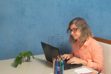 Photo for A female with laptop computer working from home or office - Royalty Free Image