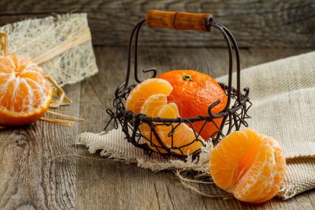 Téléchargez les photos : Un gros plan de mandarines dans un petit panier sur la table - en image libre de droit