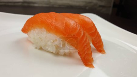 Photo for A closeup shot of a white plate containing a serving of a Nigirizushi - Royalty Free Image